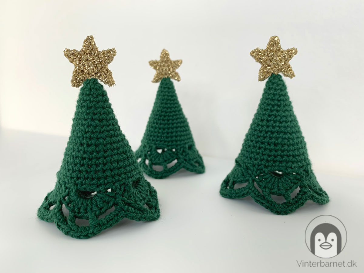 3 hæklede mini juletræer med guld stjerne på toppen.